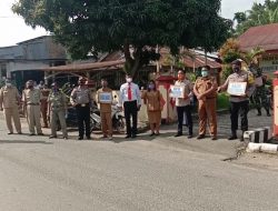 Camat STM Hilir Pimpin Apel Gabungan dan Bagi Masker ke Masyarakat